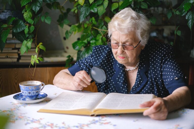 Woman Reading with Magnifying Glass