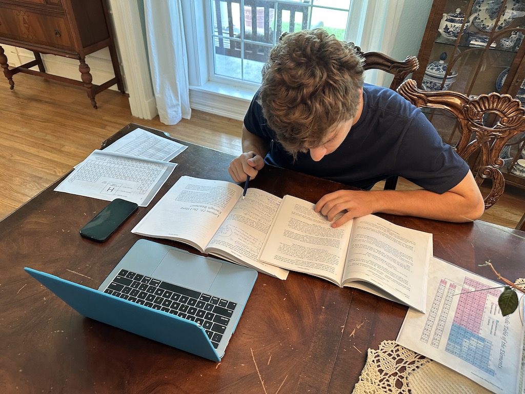 Dan Studies at Dining Table 