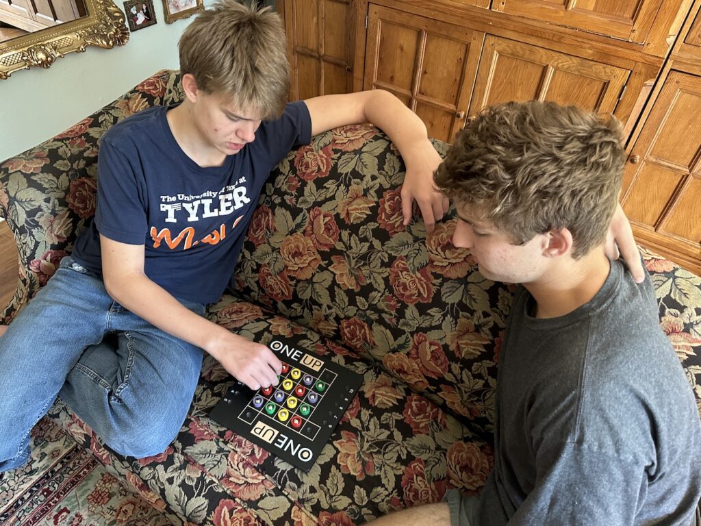 two boys playing board game
